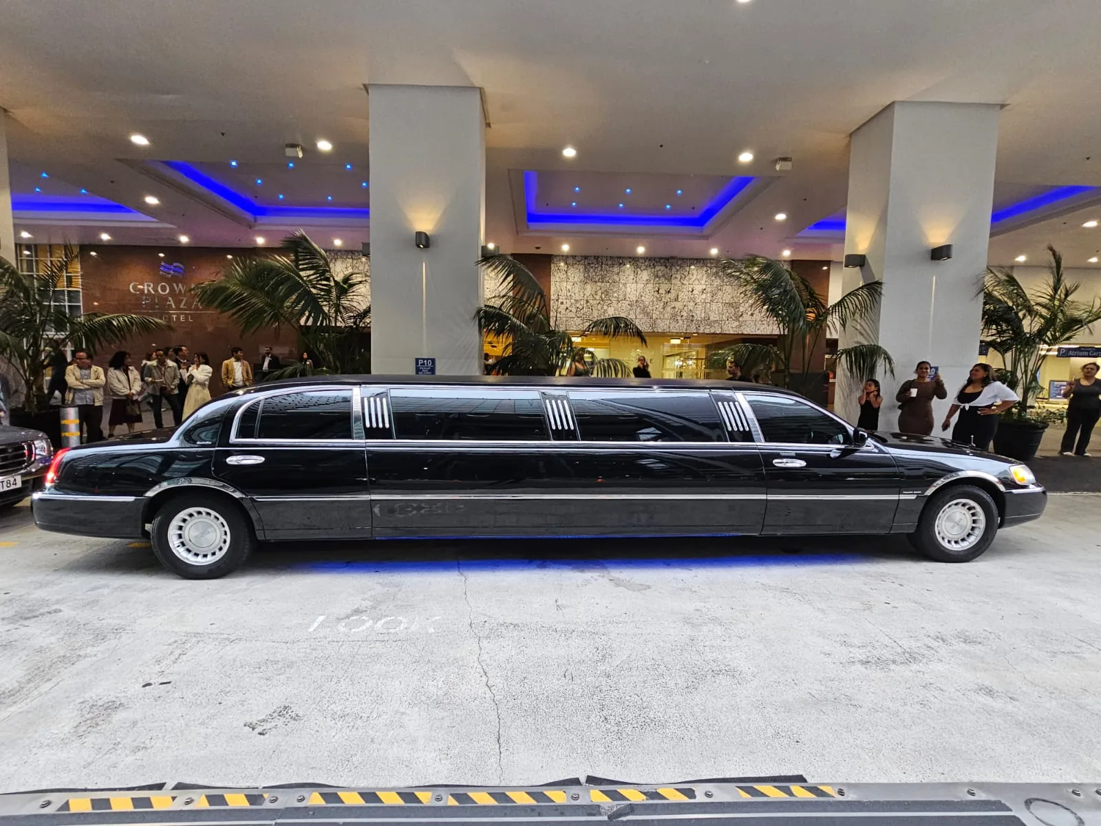 Black Lincoln stretch limo at an Auckland hotel entrance