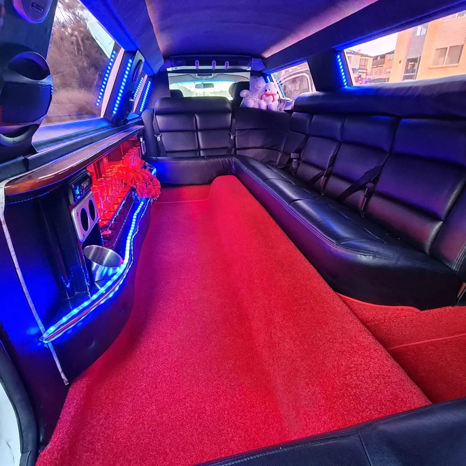 Limousine interior bar with blue mood lighting and leather seats