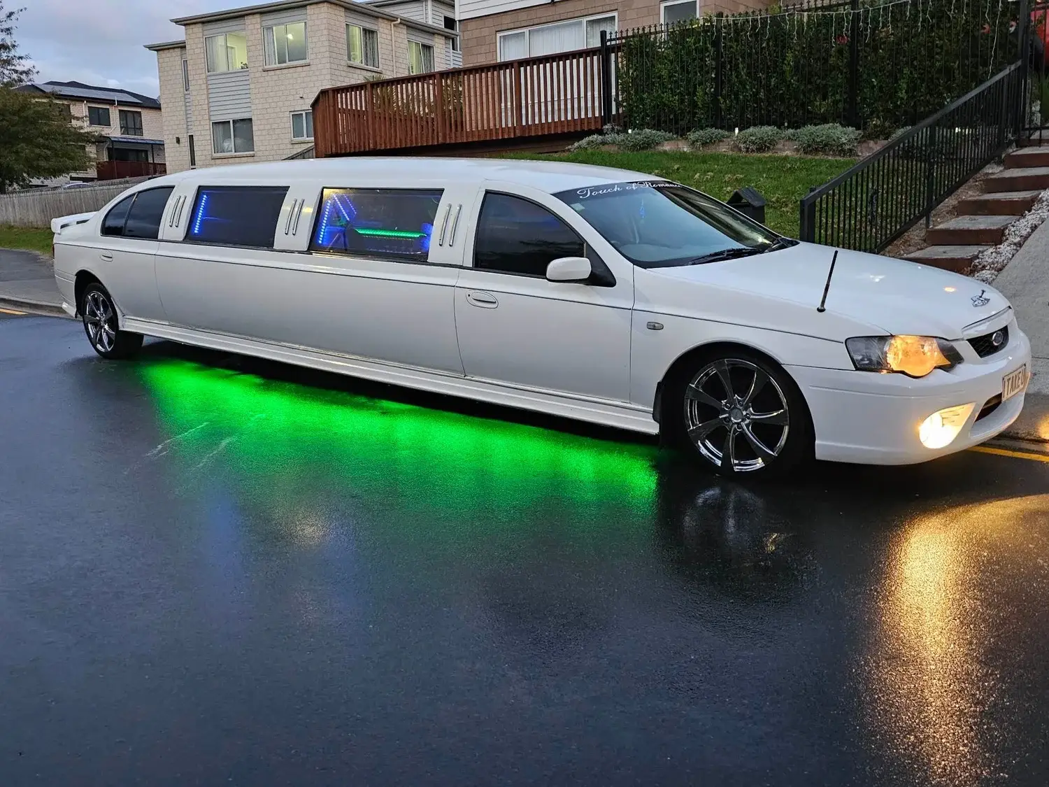 White Ford Falcon stretch limousine with green LED underglow
